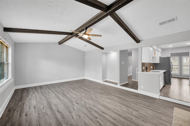 3048 Gessner Rd, Houston, TX 77080 - unfurnished living room with wood finished floors, a sink, baseboards, a ceiling fan, and recessed lighting