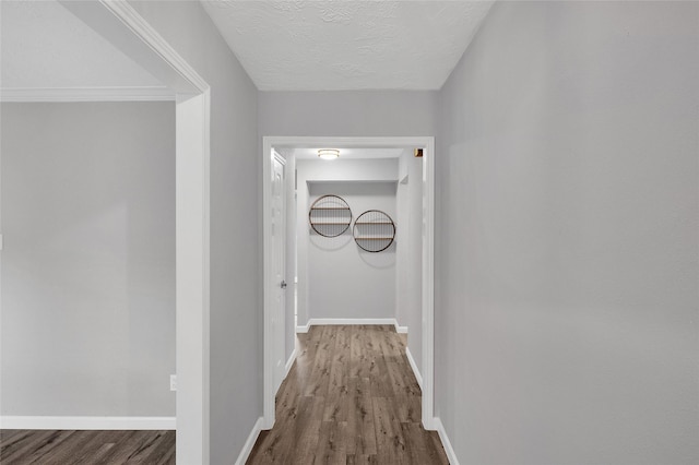 3048 Gessner Rd, Houston, TX 77080 - corridor featuring dark wood finished floors, baseboards, and a textured ceiling