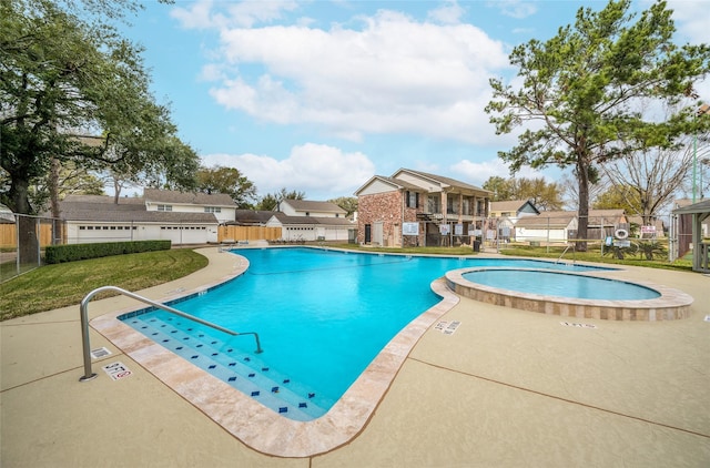 pool featuring a yard, a residential view, fence, and a patio