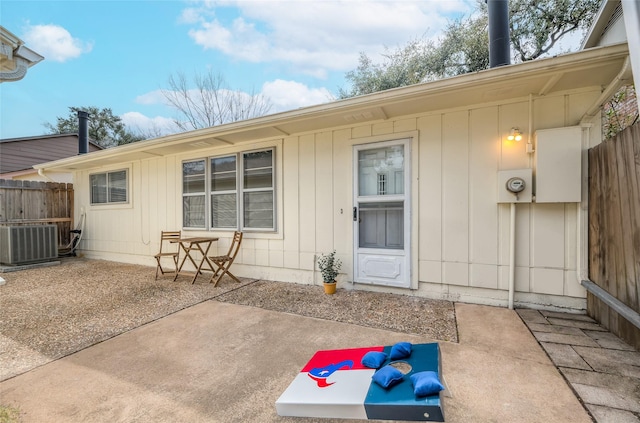 exterior space featuring a patio area, fence, and cooling unit