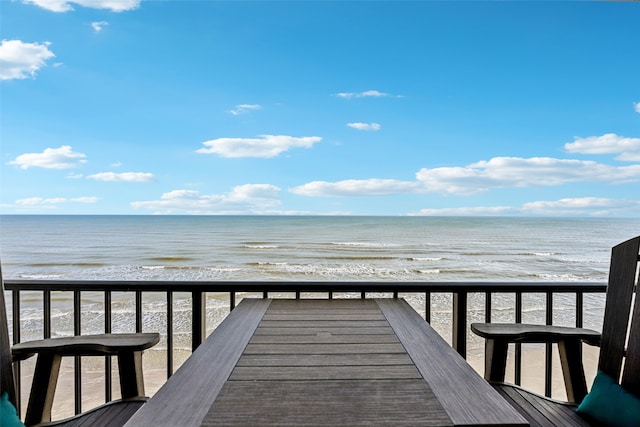 view of property's community featuring a water view and a view of the beach