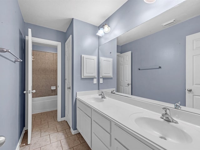 bathroom with double vanity, tile patterned flooring, a sink, and visible vents