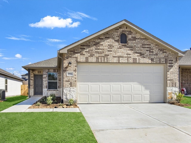 ranch-style house featuring roof with shingles, brick siding, a front lawn, and an attached garage