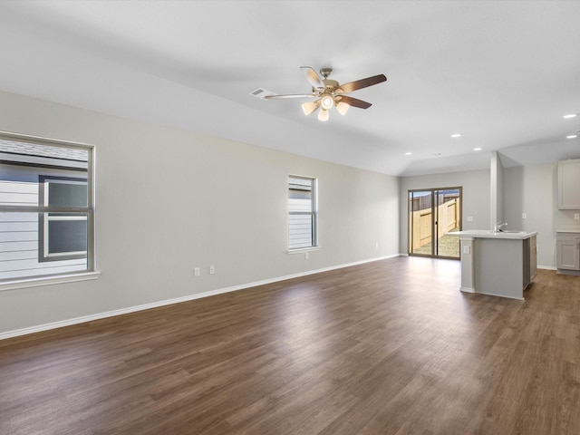 unfurnished living room with ceiling fan, baseboards, dark wood-type flooring, and recessed lighting