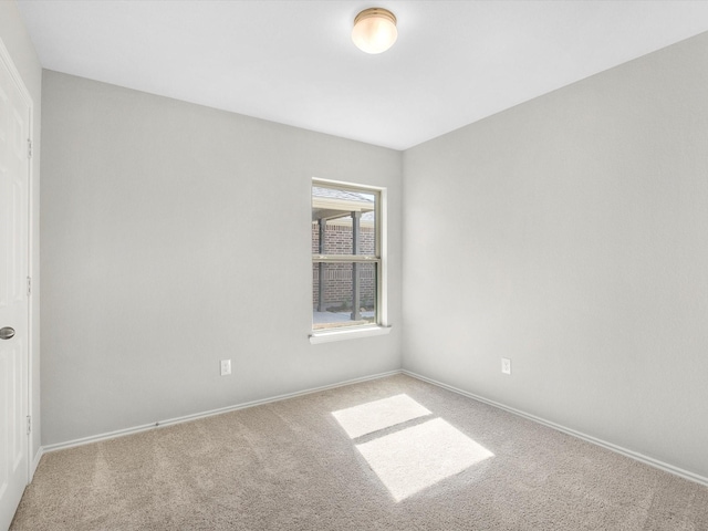 spare room with carpet floors and baseboards