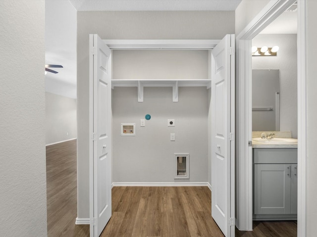 clothes washing area with washer hookup, laundry area, hookup for an electric dryer, and wood finished floors