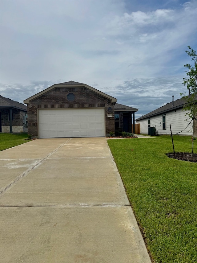 25416 Carnation Ct, Montgomery, TX 77316 - view of front of home featuring brick siding, driveway, an attached garage, and a front yard