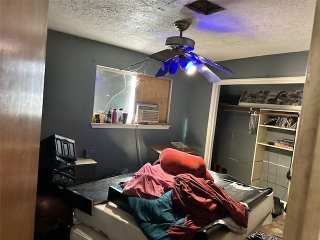 bedroom with cooling unit and a textured ceiling