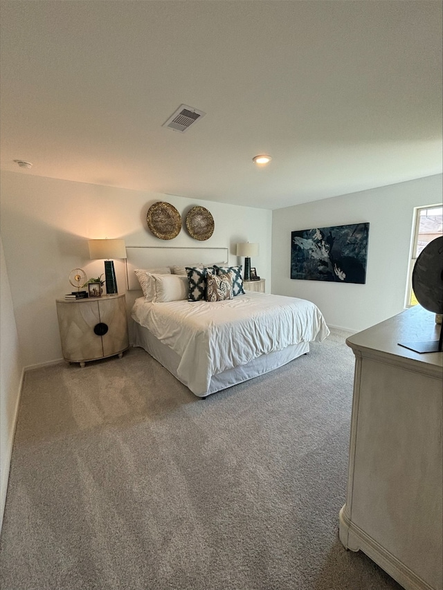 carpeted bedroom featuring visible vents