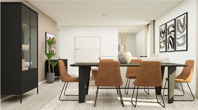 dining space with baseboards and light wood finished floors