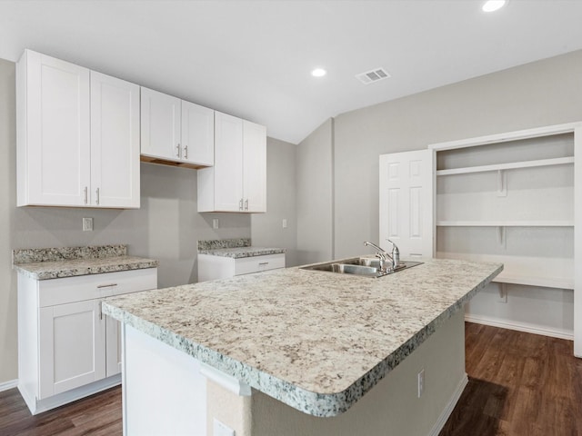 kitchen featuring dark wood-style floors, recessed lighting, visible vents, white cabinets, and a sink