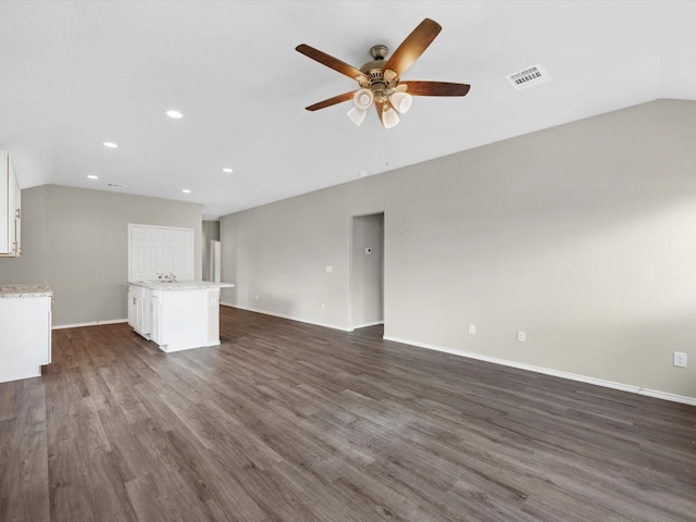 unfurnished living room featuring lofted ceiling, dark wood-style floors, ceiling fan, and visible vents