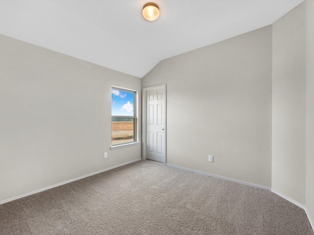 unfurnished room featuring lofted ceiling, light colored carpet, and baseboards