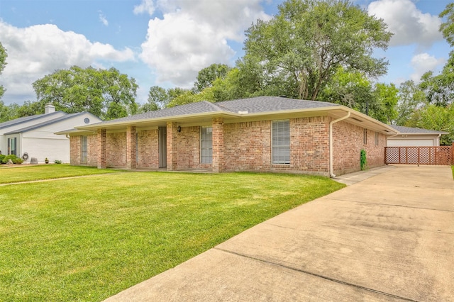 ranch-style home featuring a front yard and brick siding