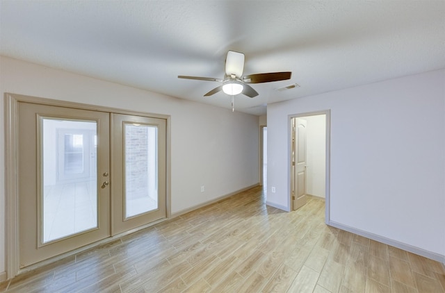 unfurnished bedroom featuring light wood finished floors, french doors, visible vents, and access to exterior