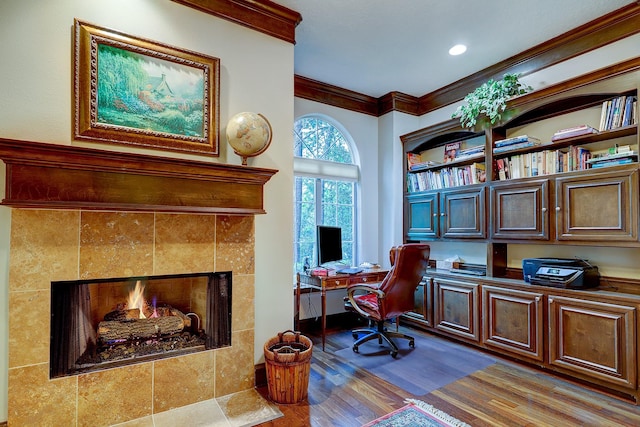 37314 Edgewater Dr, Pinehurst, TX 77362 - office space featuring a tile fireplace, wood finished floors, ornamental molding, built in study area, and recessed lighting