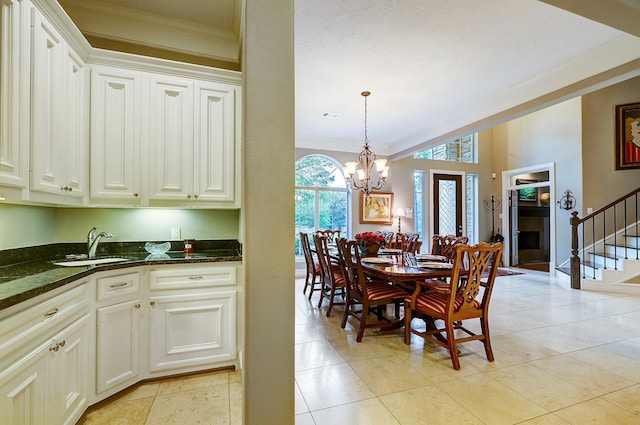 37314 Edgewater Dr, Pinehurst, TX 77362 - dining room featuring crown molding, stairs, a chandelier, and light tile patterned floors