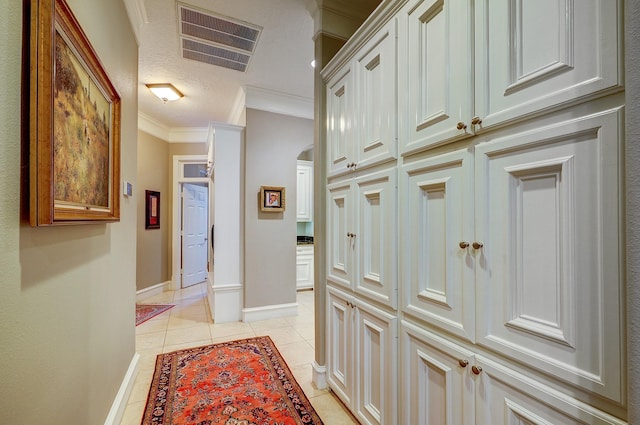 37314 Edgewater Dr, Pinehurst, TX 77362 - hall featuring crown molding, light tile patterned floors, baseboards, and arched walkways
