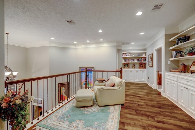 37314 Edgewater Dr, Pinehurst, TX 77362 - living area featuring ornamental molding, a chandelier, wood finished floors, a textured ceiling, and recessed lighting