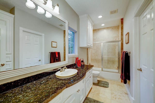 37314 Edgewater Dr, Pinehurst, TX 77362 - full bathroom with toilet, vanity, bath / shower combo with glass door, tile patterned flooring, and recessed lighting