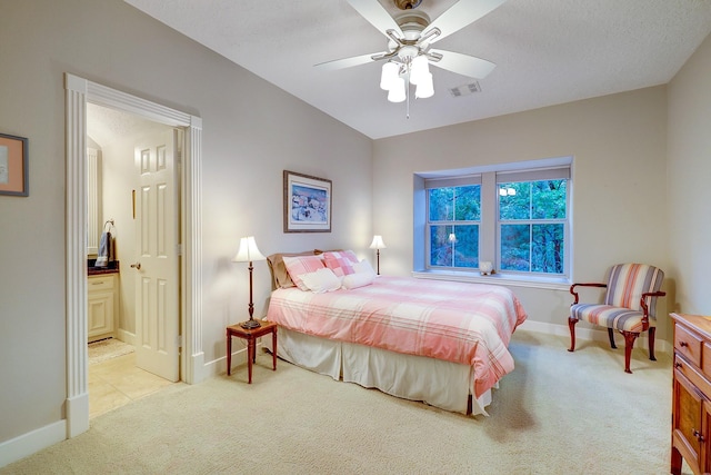 37314 Edgewater Dr, Pinehurst, TX 77362 - bedroom featuring light colored carpet, baseboards, ensuite bathroom, and ceiling fan