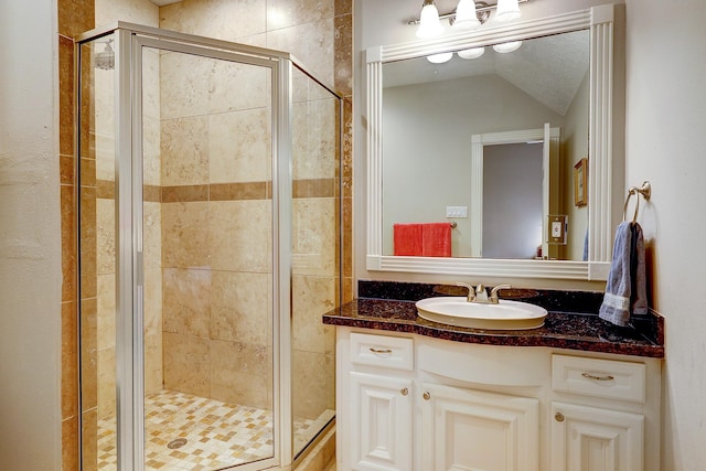 37314 Edgewater Dr, Pinehurst, TX 77362 - bathroom with a shower stall, vanity, and lofted ceiling