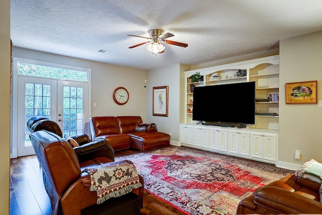 37314 Edgewater Dr, Pinehurst, TX 77362 - living room featuring ceiling fan, a textured ceiling, french doors, baseboards, and wood finished floors