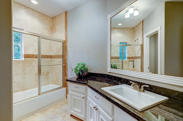 37314 Edgewater Dr, Pinehurst, TX 77362 - full bathroom with vanity, tiled shower / bath combo, and a textured ceiling