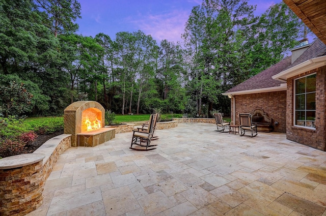 37314 Edgewater Dr, Pinehurst, TX 77362 - view of patio with a warm lit fireplace and a fire pit