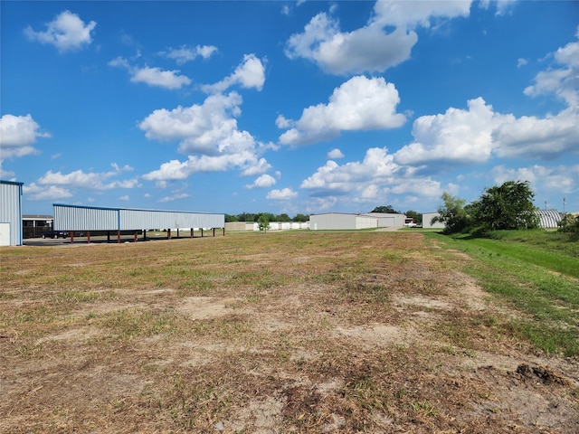 view of yard with a pole building and an outbuilding