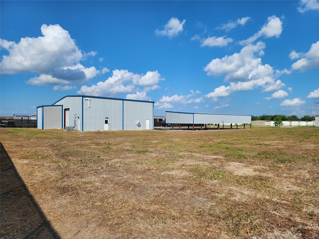 view of yard featuring an outbuilding and a pole building