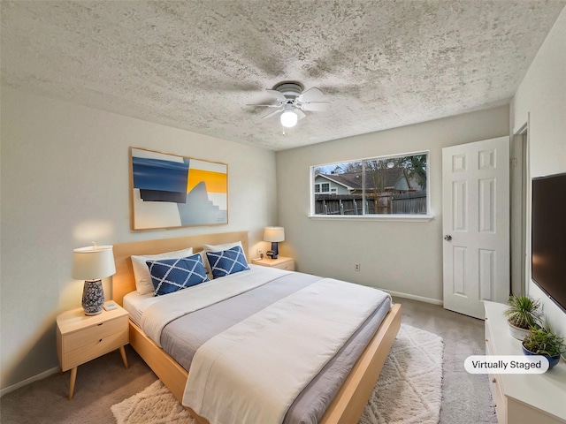 bedroom with a ceiling fan, carpet, a textured ceiling, and baseboards