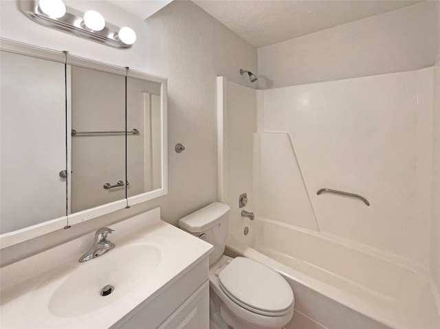 full bathroom featuring toilet, a textured ceiling, washtub / shower combination, and vanity