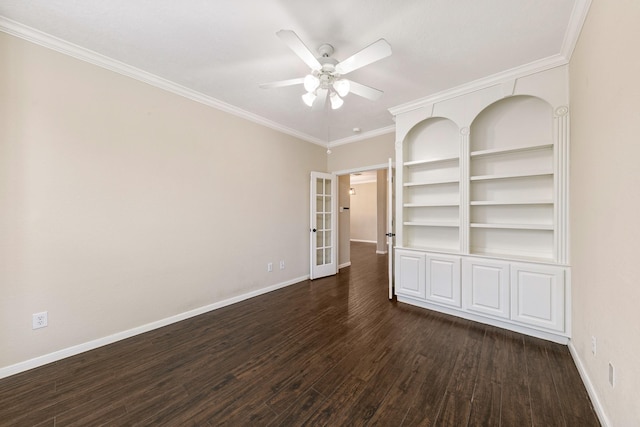 empty room with dark wood-type flooring, built in features, ornamental molding, and baseboards