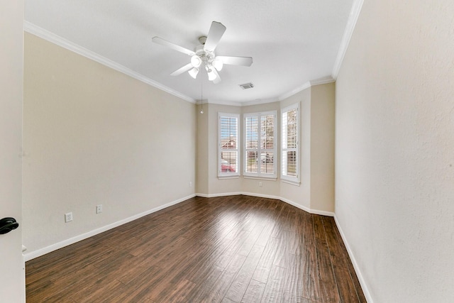 unfurnished room featuring dark wood-type flooring, visible vents, crown molding, and baseboards