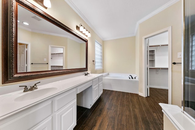 full bath with ornamental molding, a sink, and wood finished floors