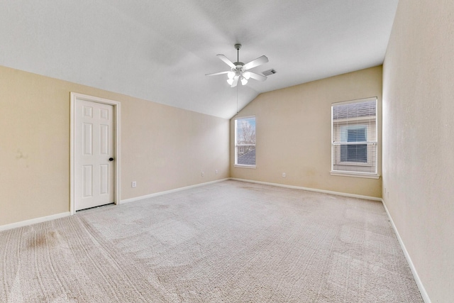 unfurnished room with lofted ceiling, carpet, ceiling fan, and baseboards