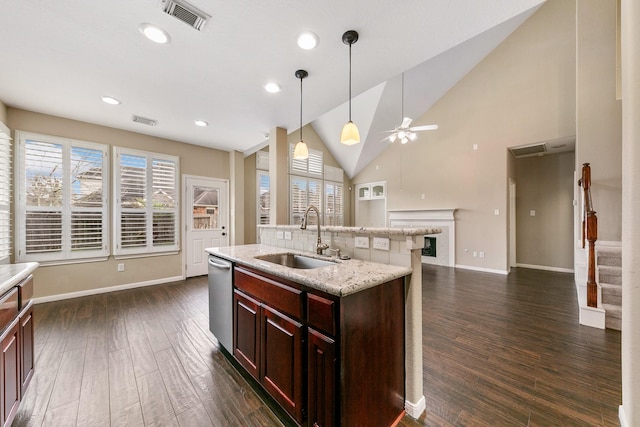 kitchen with dark wood finished floors, visible vents, a sink, and dishwasher