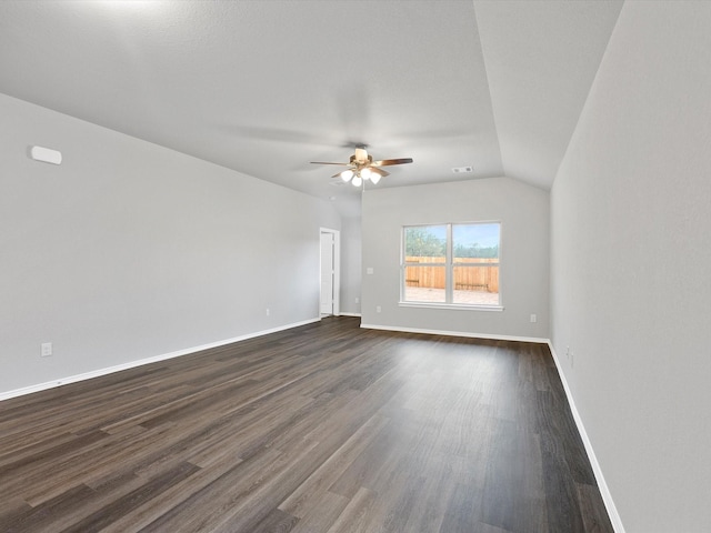 unfurnished room featuring lofted ceiling, a ceiling fan, baseboards, and dark wood-style flooring