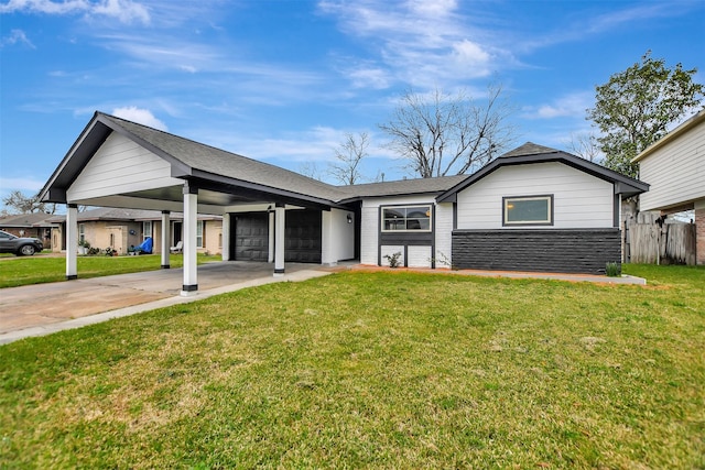 single story home with an attached garage, a front yard, an attached carport, stone siding, and driveway