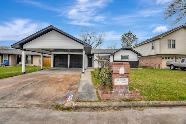 view of front of house with an attached garage, concrete driveway, a carport, and a front yard