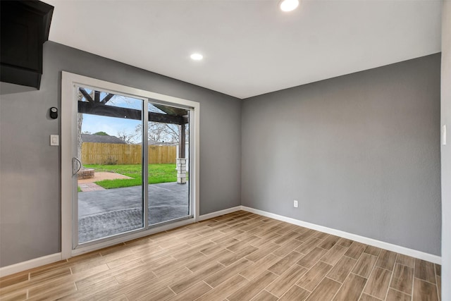 unfurnished room with wood tiled floor, baseboards, and recessed lighting