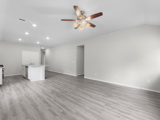 unfurnished living room featuring light wood-type flooring, visible vents, and baseboards