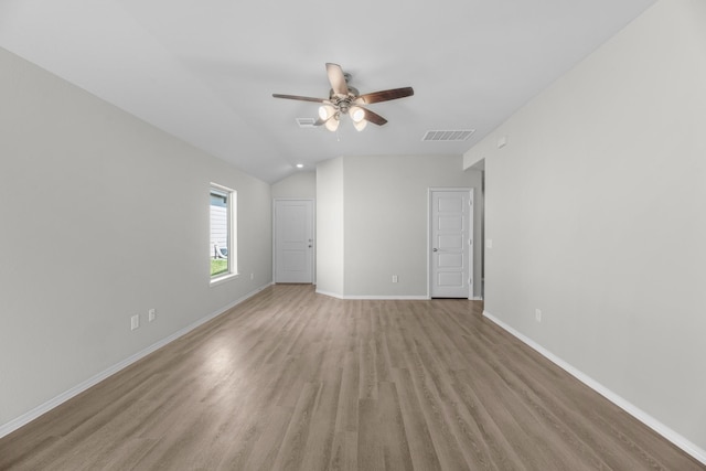 empty room with light wood finished floors, baseboards, visible vents, and ceiling fan