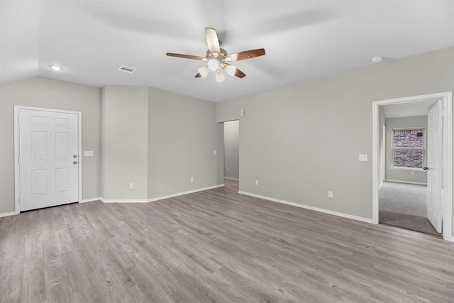 empty room with visible vents, ceiling fan, and wood finished floors