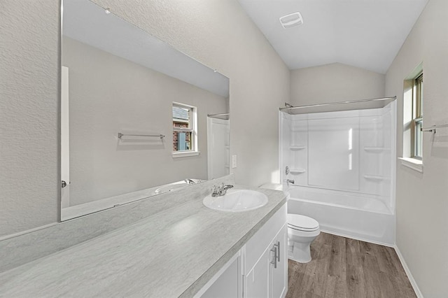 full bathroom with toilet, shower / bath combination, wood finished floors, visible vents, and vaulted ceiling