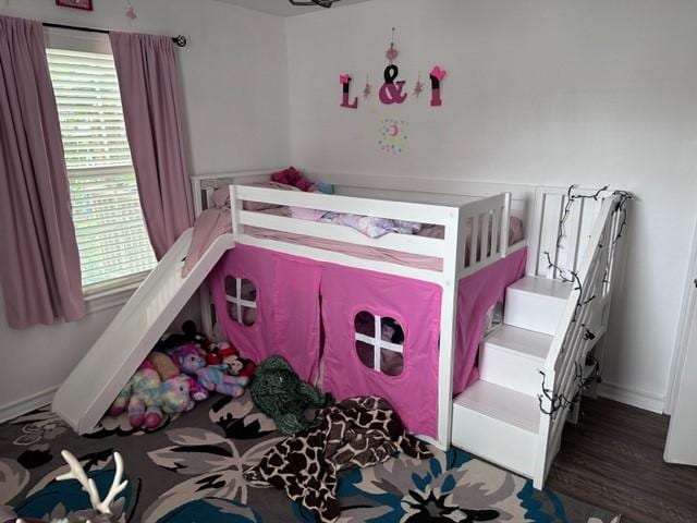 bedroom with wood finished floors and baseboards