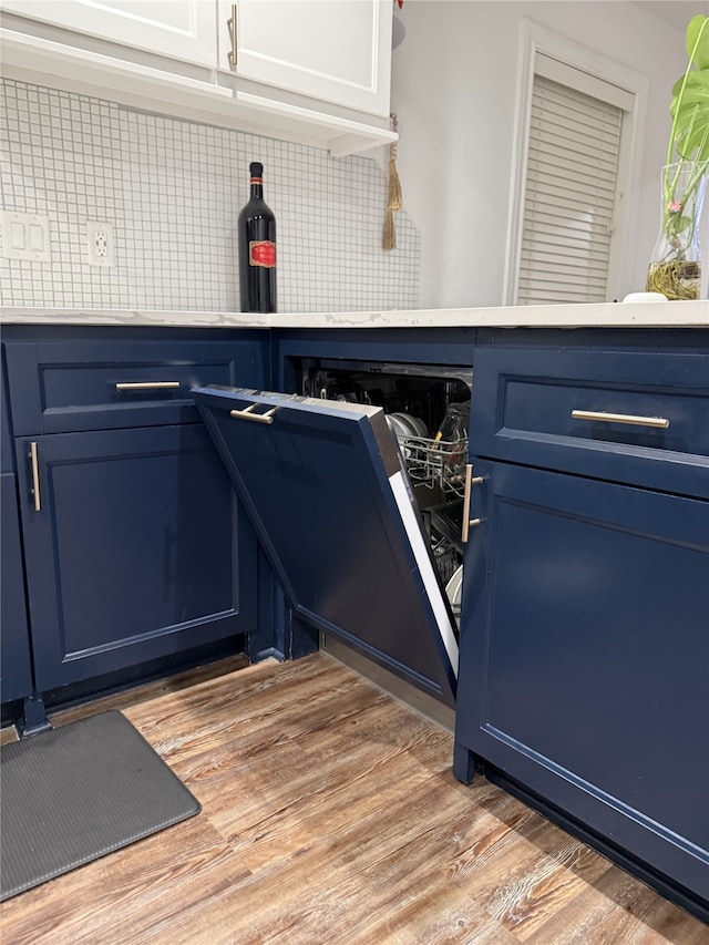 interior space featuring light wood-type flooring and tasteful backsplash