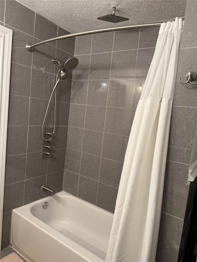 bathroom featuring shower / bath combo and a textured ceiling