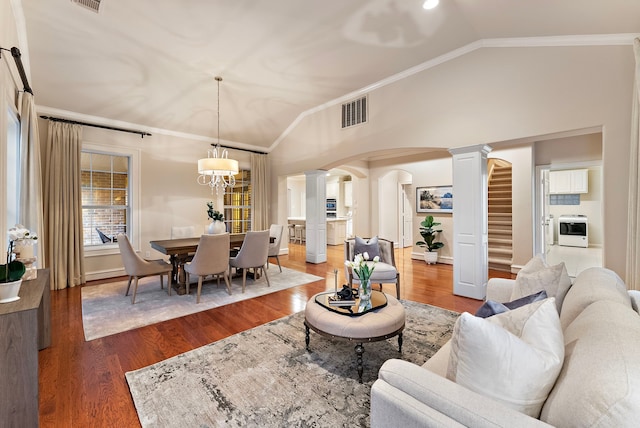 living area with lofted ceiling, ornate columns, arched walkways, and crown molding